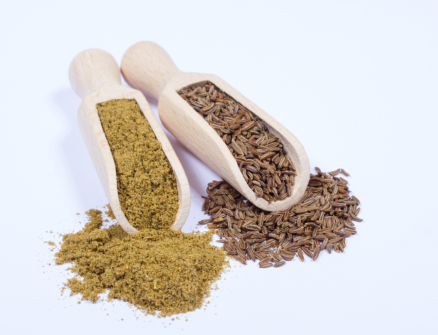 Ground Cumin In A Spoon And Whole Cumin