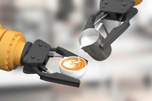One robotic arm holds a latte while another robotic arm pours the foam over top